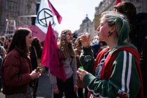 A woman blows bubbles while campaigners block Oxford Circus