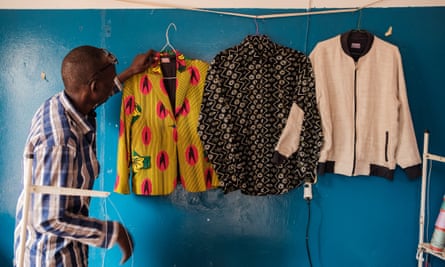 Bada Seck in her workshop with clothes hanging on a wall