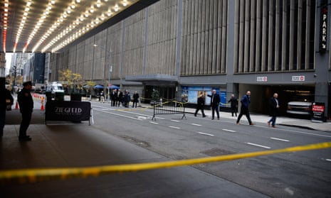 UnitedHealthcare CEO’s wife calls shooting ‘senseless killing’ as police release images of suspect – latest updates a line of police tape blocks off a street