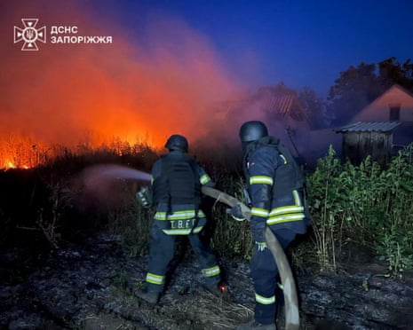 Firefighters battle a fire in the aftermath of a Russian military strike, amid Russia's attack on Ukraine, in a location given as Zaporizhzhia Region, Ukraine.