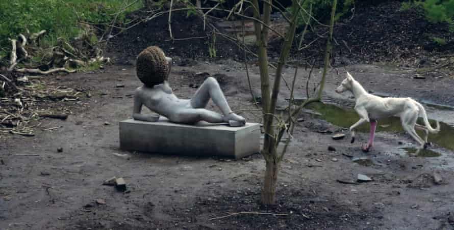 The dog called Human and the bee-encrusted statue in Huyghe’s compost garden at Documenta.