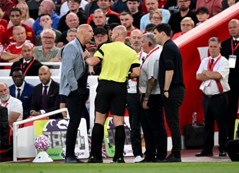 Anthony Taylor speaks with both benches after a racist comment from from someone in crowd to Antoine Semenyo.