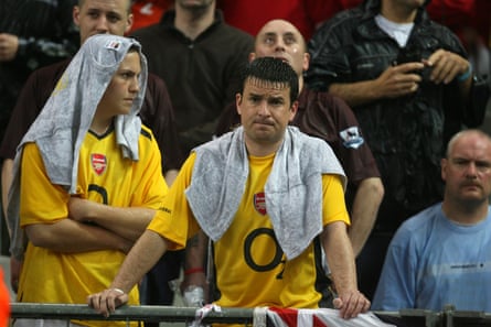 Dejected Arsenal fans in the rain after losing 2-1.