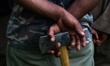 A man holds an axe in Enga Province in 2019