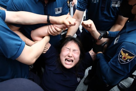 A South Korean protester is detained by police outside the Japanese embassy in Seoul on Thursday after Japan began releasing wastewater from the ruined Fukushima nuclear power plant. 