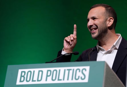 Zack Polanski at the party conference in Bournemouth at a podium with the sign ‘bold politics’