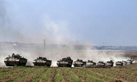 A column of Israeli armoured personnel carriers near the Gaza border in southern Israel