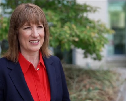 Rachel Reeves being interviewed the next day, looking confident and giving a small smile; she wears a red shirt and dark blue jacket.