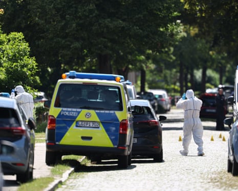 Police and rescue personnel work near the scene where five people were killed in a shooting in Stade, northern Germany.