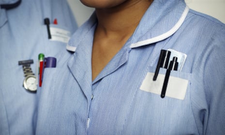Close-up of two typically dressed NHS (National Health Service) nurses