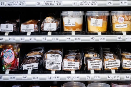 A vending machine stocked with brownies, banoffee pie, cakes, sandwiches and other treats.