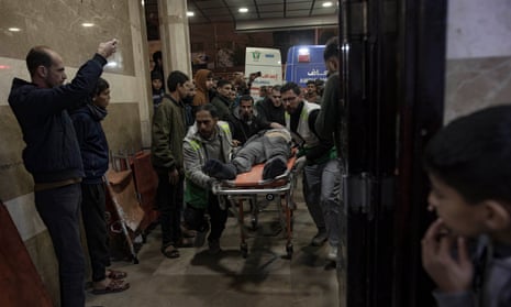An injured man is brought to Nasser hospital on Tuesday after Israeli airstrikes