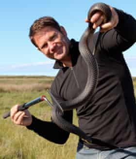 Steve Backshall with a highly venomous copperhead snake, in a still from the TV series Deadly 60