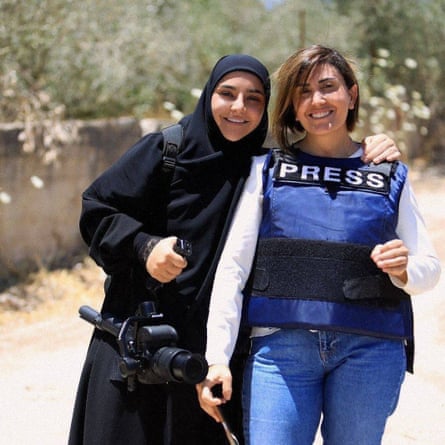 Zeinab Faraj, left, in hijab, with Amal Khalil, wearing a vest saying ‘PRESS’