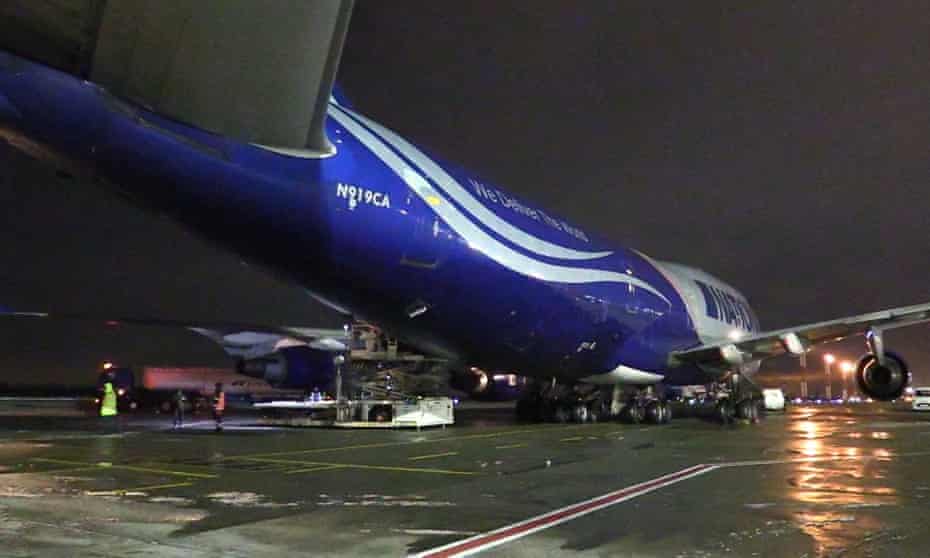 Workers unload a shipment of military aid delivered as part of the US security assistance to Ukraine.
