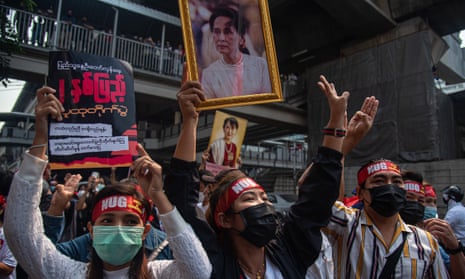 Protesters in Myanmar hold portraits of deposed leader Aung San Suu Kyi outside the country’s embassy in Bangkok, Thailand, on the Myanmar military takeover anniversary