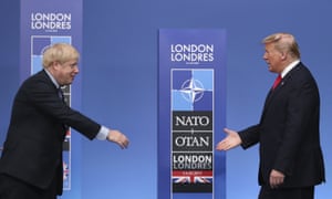 Boris Johnson reaches out to shake hands with Donald Trump before a Nato leaders’ meeting in Watford, December class=