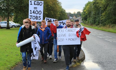People take part in a protest march to Green Pastures church in Ballymena, Northern Ireland
