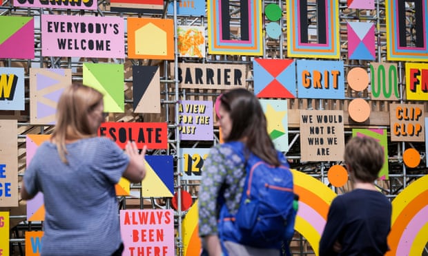 Members of the public look at the words painted on to the structure