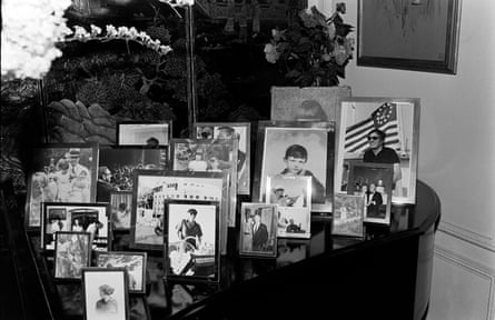 Rows of framed family photographs on a table