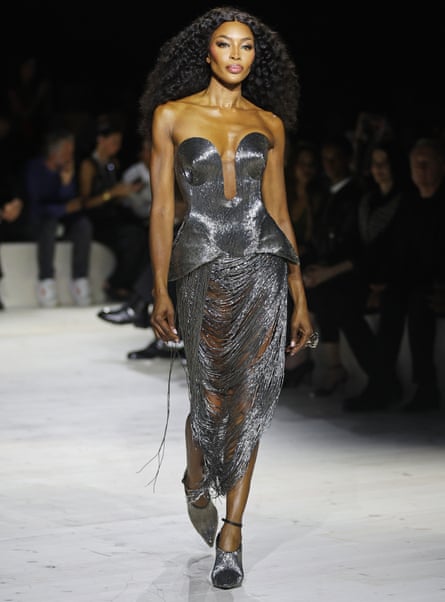 Naomi Campbell wears a silver mesh skirt and fitted sleeveless bodice on the catwalk
