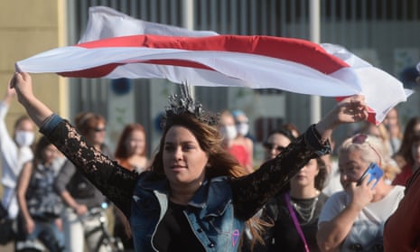 A marcher holds a flag during a protest against Belarusian president Alexander Lukashenko in Minsk on Saturday