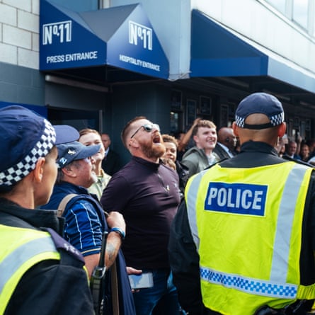 A man shouts at West Ham team bus outside the Den