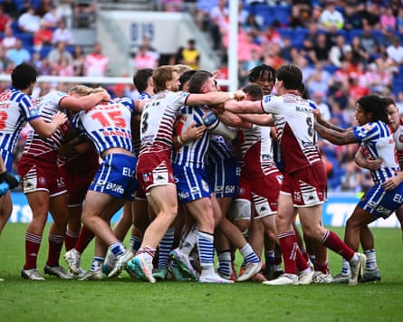The Wigan and St Helens players tangle during a physical encounter between the rivals