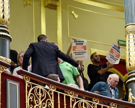 A group of people protest from the stands during an extraordinary parliamentary session to vote on a government housing decree at the Congress of Deputies in Madrid.