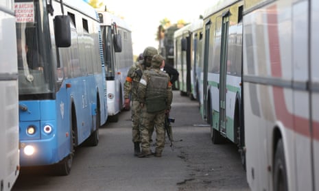 Buses wait to transport surrendered members of the Azov battalion in Mariupol