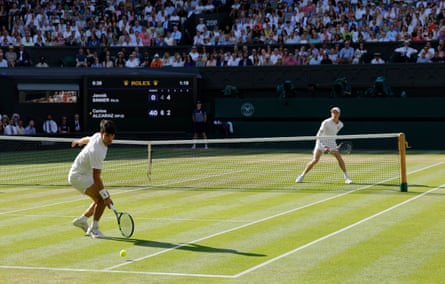 Carlos Alcaraz watches as a Jannik Sinner winner passes him in the men’s singles Wimbledon final on Centre Court