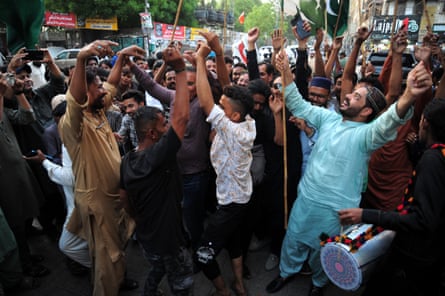 Pakistani people dance and celebrate after a ceasefire was agreed between Pakistan and India, in Hyderabad
