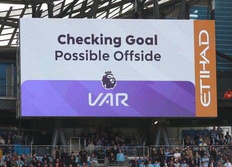 A screen in the stadium indicates a VAR check is ongoing.