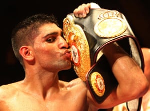Khan kisses his belt as he celebrates victory over Andreas Kotelnik.