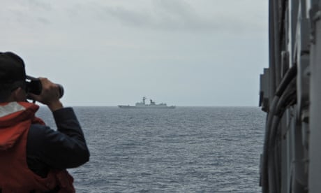 In this file photograph from August 2023 a Taiwanese sailor monitors a Chinese frigate at an undisclosed location. China has stepped up warship and fighter plane movements, Taipei has said.