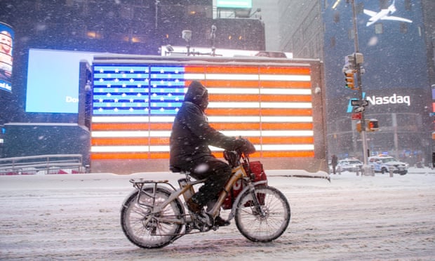 A Grubhub delivery driver rides through Times Square during the Nor'easter snow storm on 1 February 2021 in New York City. 