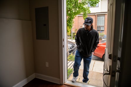 man standing in the doorway of a house, about to walk in