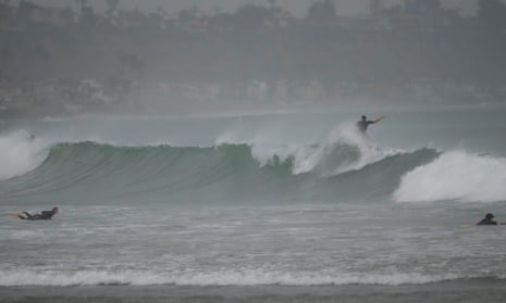 Surfers ride waves off Doheny State Park Beach in Dana Point, California.
