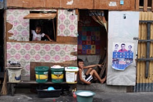 Two children pose for the photo in their shanty in Delpan slum, in Binondo district, Manila, where it’s really difficult to keep social distance guidelines under quarantine.