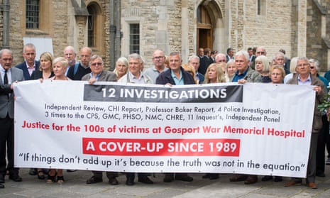 Family members of people who died at Gosport War Memorial hospital hold up a protest banner