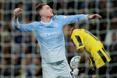 Elliot Anderson celebrates scoring for Manchester City behind the net.
