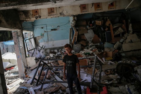 An internally displaced Palestinian boy stands among the rubble at the Unrwa-run school turned shelter of Al-Jawni, a day after the structure was hit by an Israeli airstrike on 11 September.