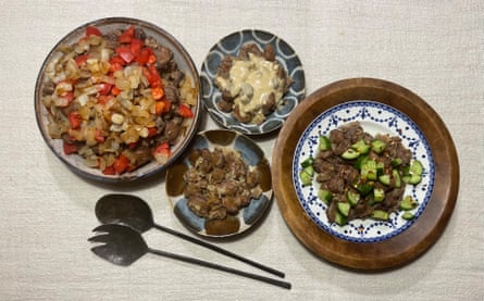 Ful medames, presented in four bowls, with different garnishes including chopped tomato and onion, tahini, chopped cucumber, and garlic and cumin.