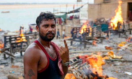Ganga Ram Chowdhary, who works at a cremation ground, shows his inked finger after casting his ballot in the seventh and final phase of voting in India’s general election.