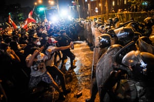Demonstrators confront riot police during a protest against Merino’s new government following the impeachment and removal of Vizcarra on 12 November