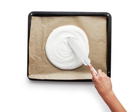 Top view of a palette knife wiping a pavlova