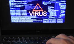 computer, hand and screen saying VIRUS