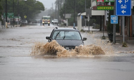 A car drives on a flooded street in Laidley, south-east Queensland, in May