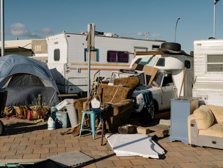 An RV, a tent and other objects including furniture.
