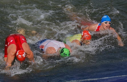 The men’s competitors get out of the river Seine after the swimming leg of the triathlon